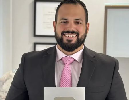 John R. De La Vega, Esq.